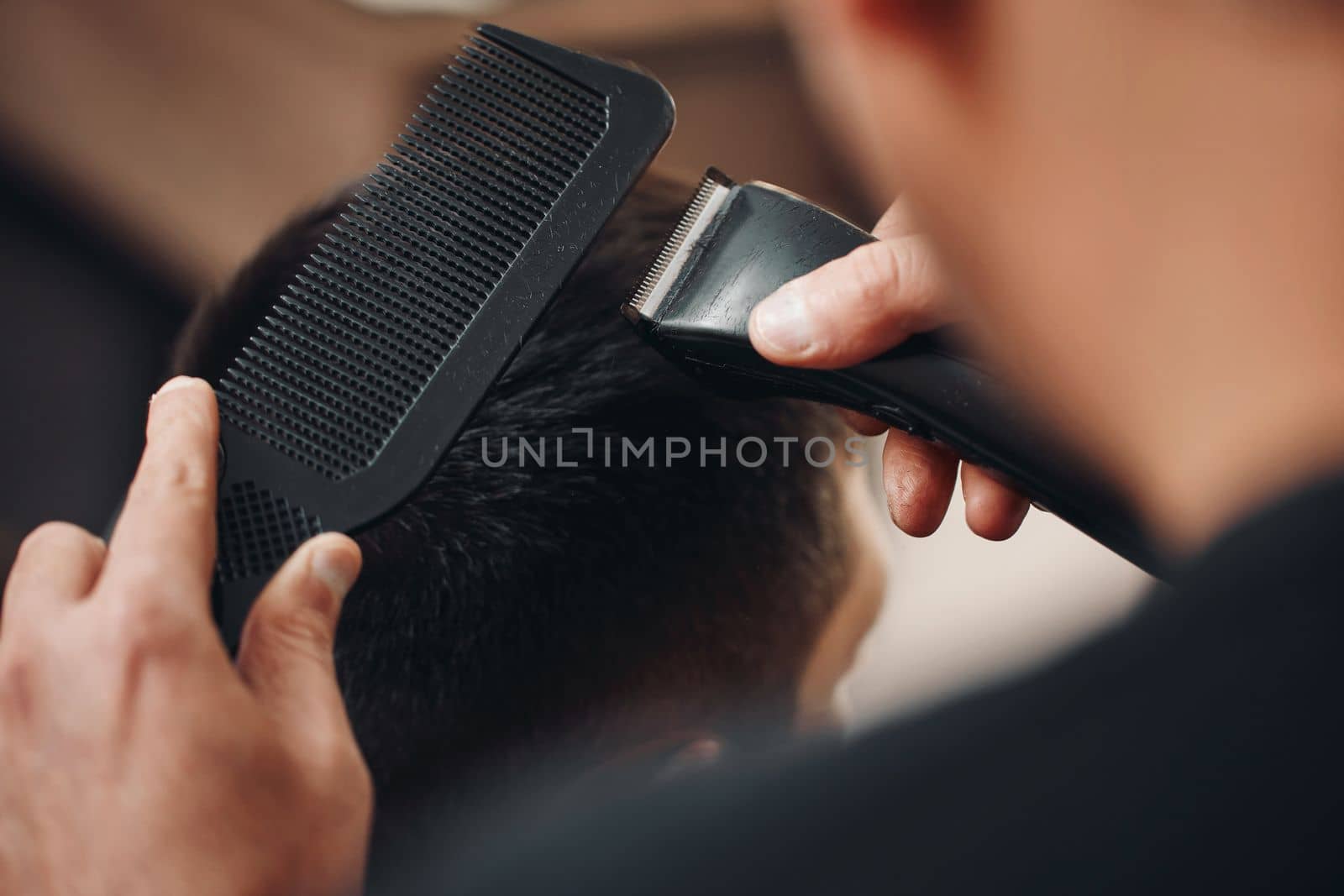 Barber shaving caucasian man in barber shop. close-up