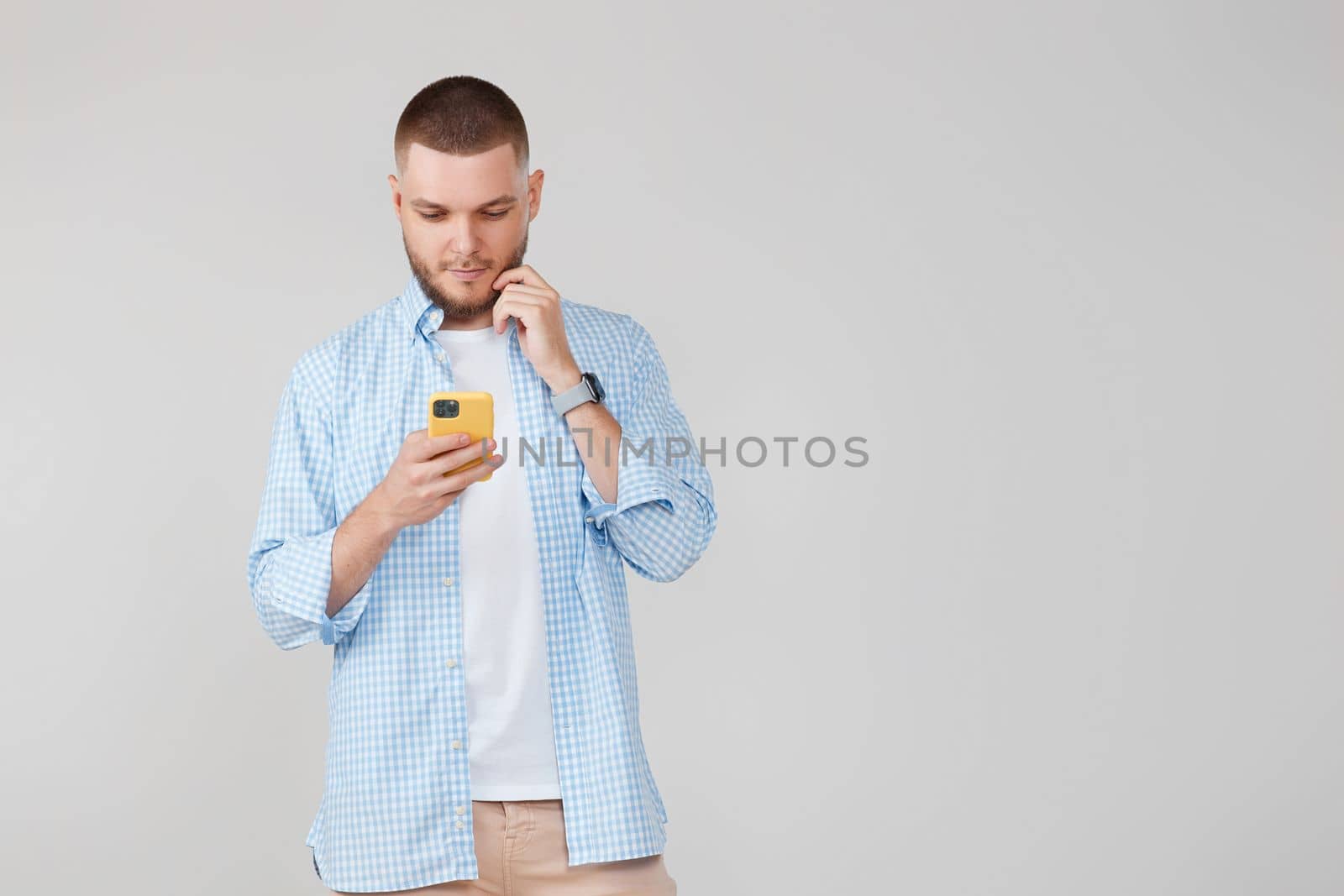 handsome man with mobile cell phone surfing internet. copy space