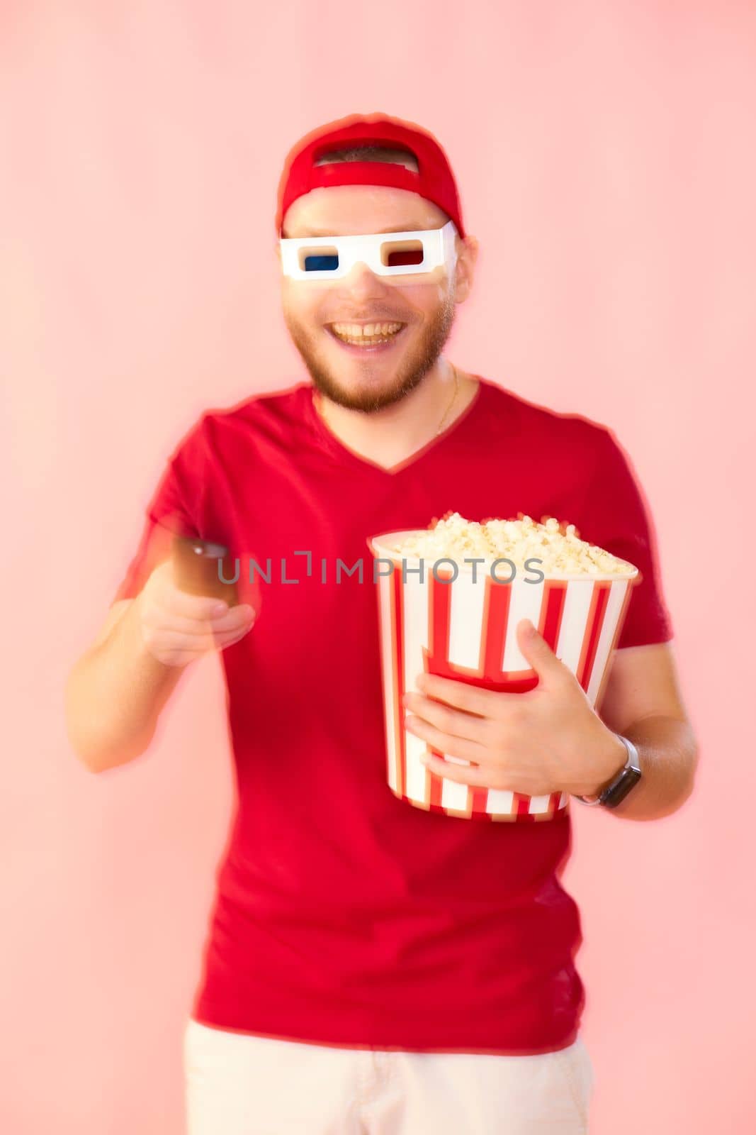 smiling man in 3d glasses using console watching movie isolated on pink background