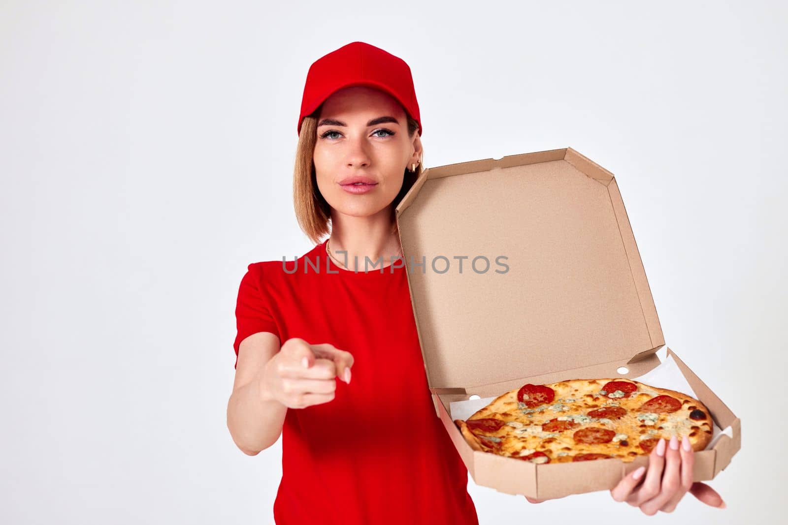 pizza delivery girl pointing to the camera and to you isolated on white background