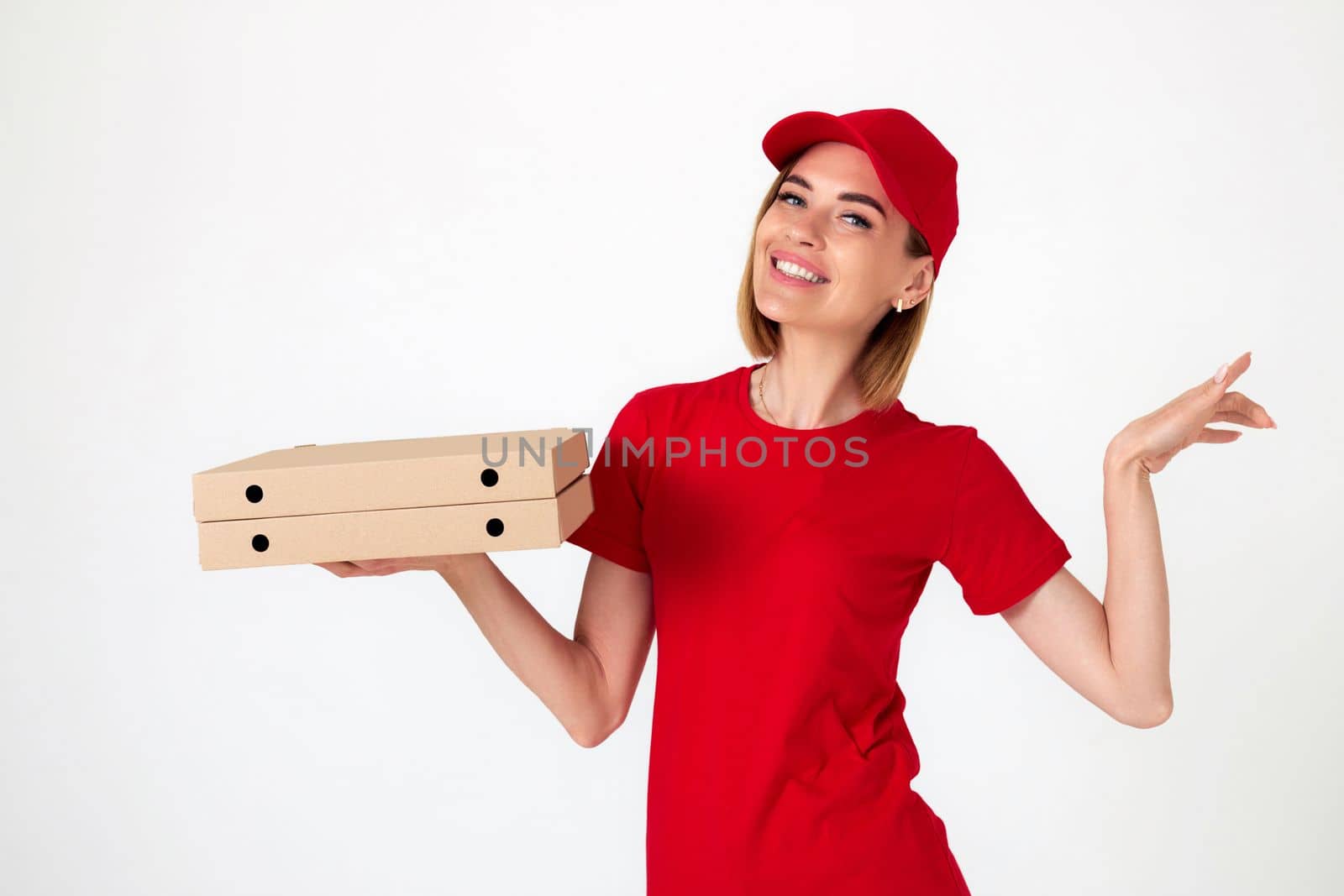 smiling pizza delivery woman in uniform holding pizza boxes on white background