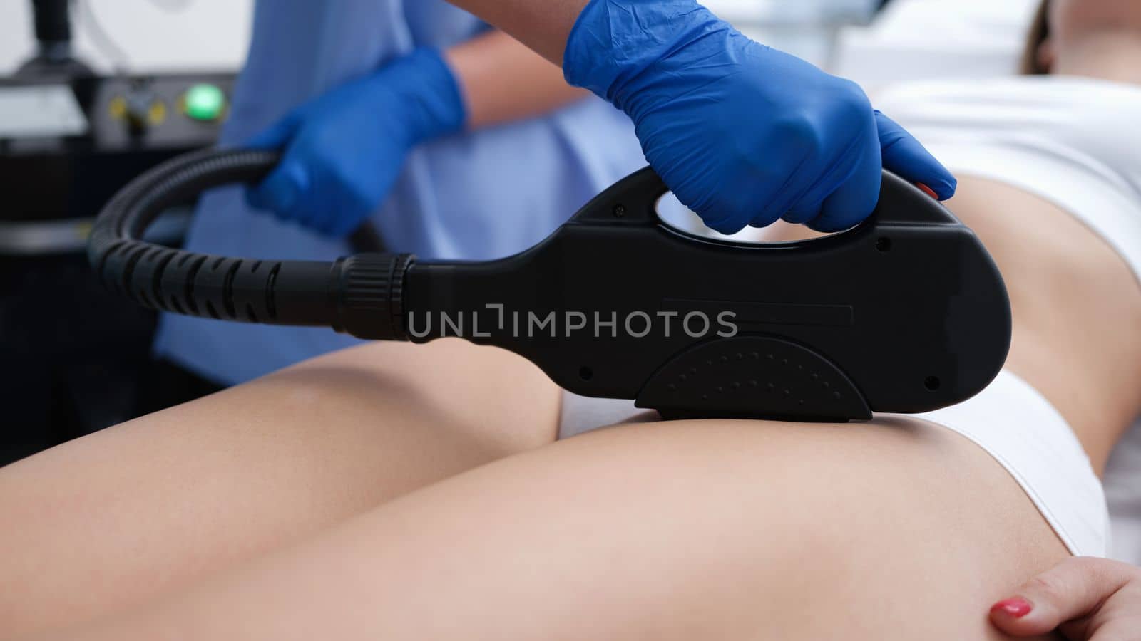 Beautician removes hair in bikini area with laser. Young woman getting laser hair removal of bikini area in clinic