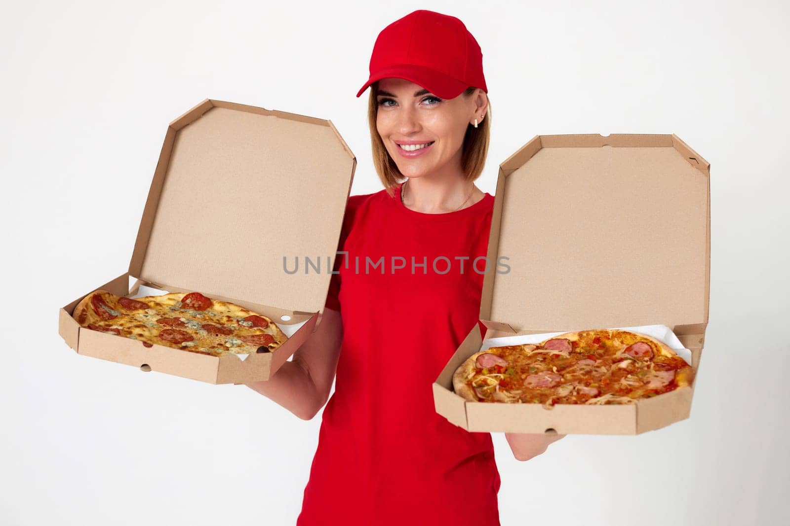pizza delivery girl showing showing opened boxes with delicious pizza on white background