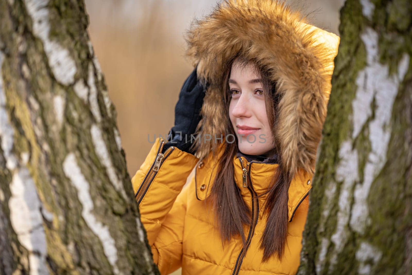 portrait of a beautiful teenage girl at sunset in nature between the birches by Edophoto