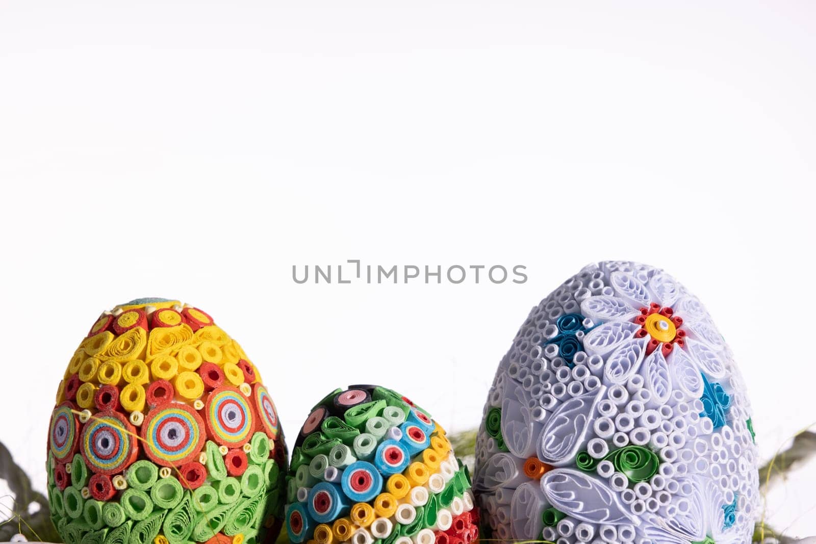 A masterpiece of handmade Easter eggs can be seen on a uniform clean background. Ornaments in honor of the Christian holiday.