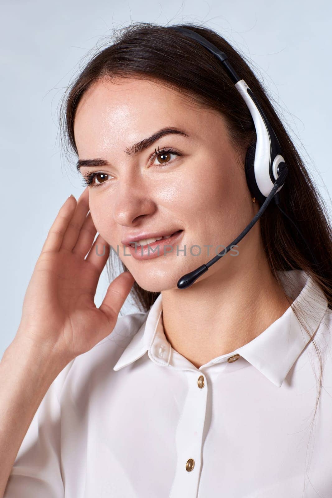 Portrait of beautiful woman in headset is consulting clients online. Call center, business people concept