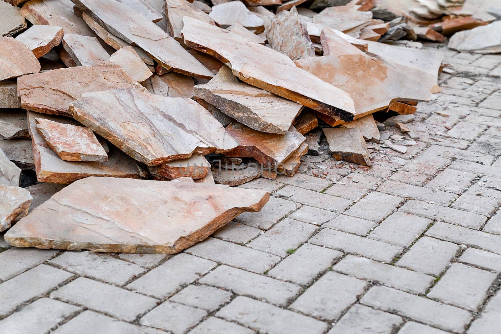 Heap of natural brown facing stone for walls and laying paths, copy space