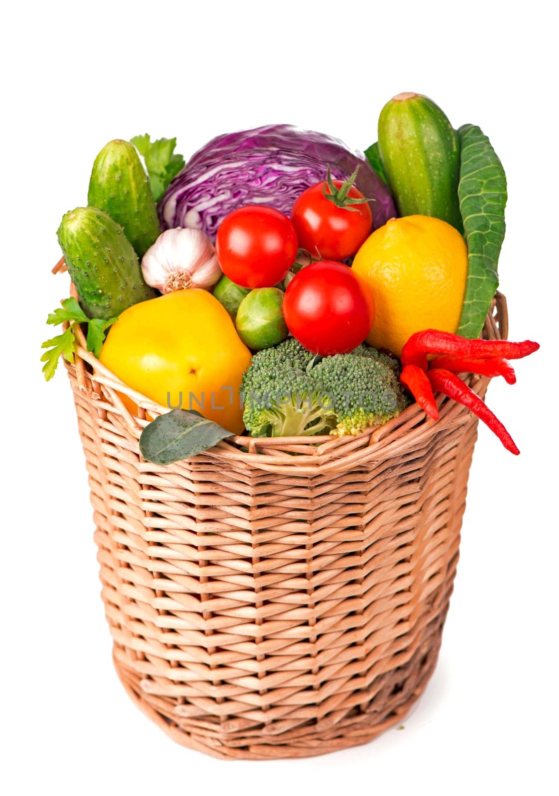 Fruits and vegetables in the basket isolated on white