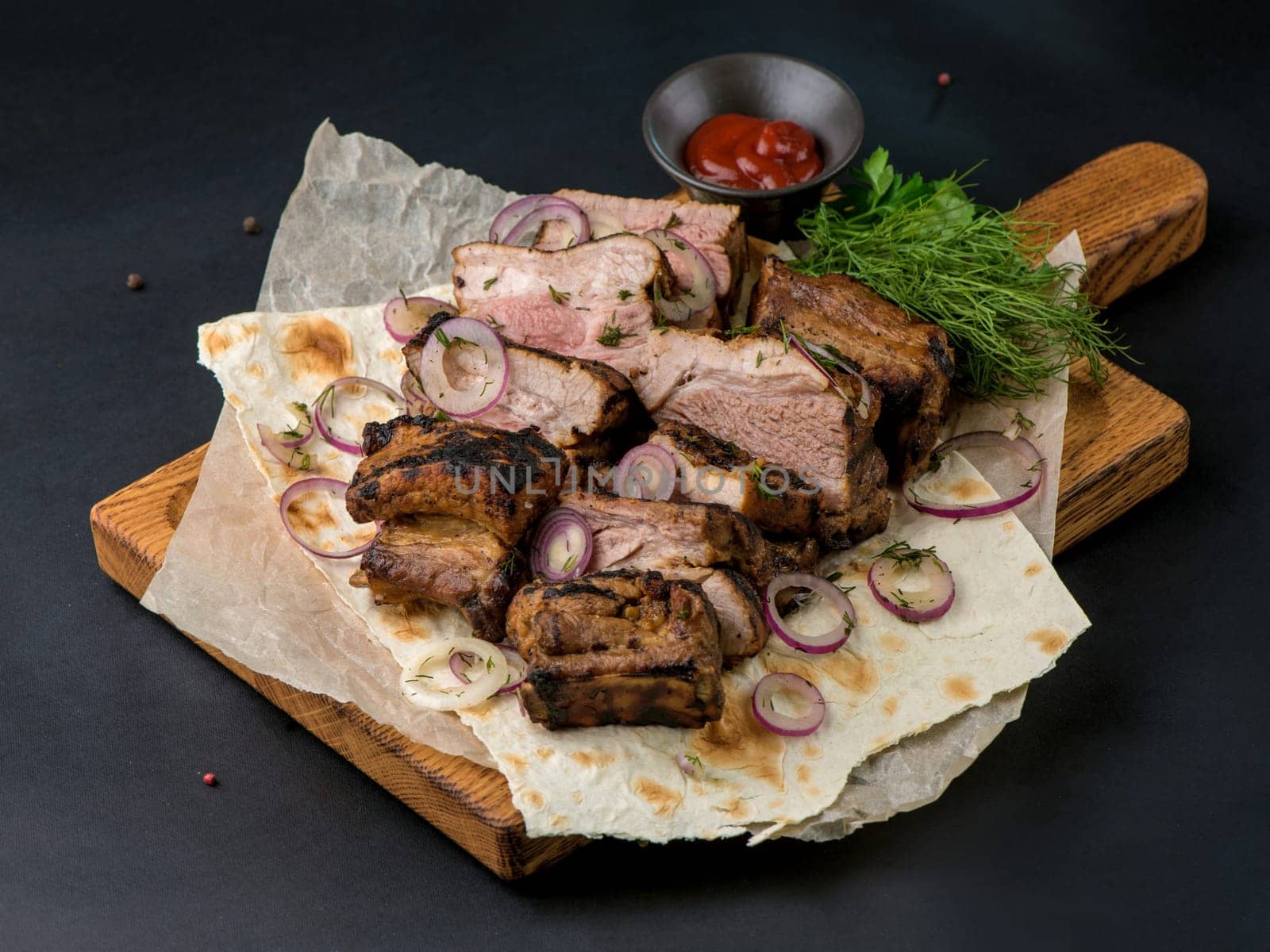 Assorted delicious grilled meat with vegetable. Mixed grilled meat with vegetables. Mixed grilled meat on wooden platter. Copyspace. by aprilphoto