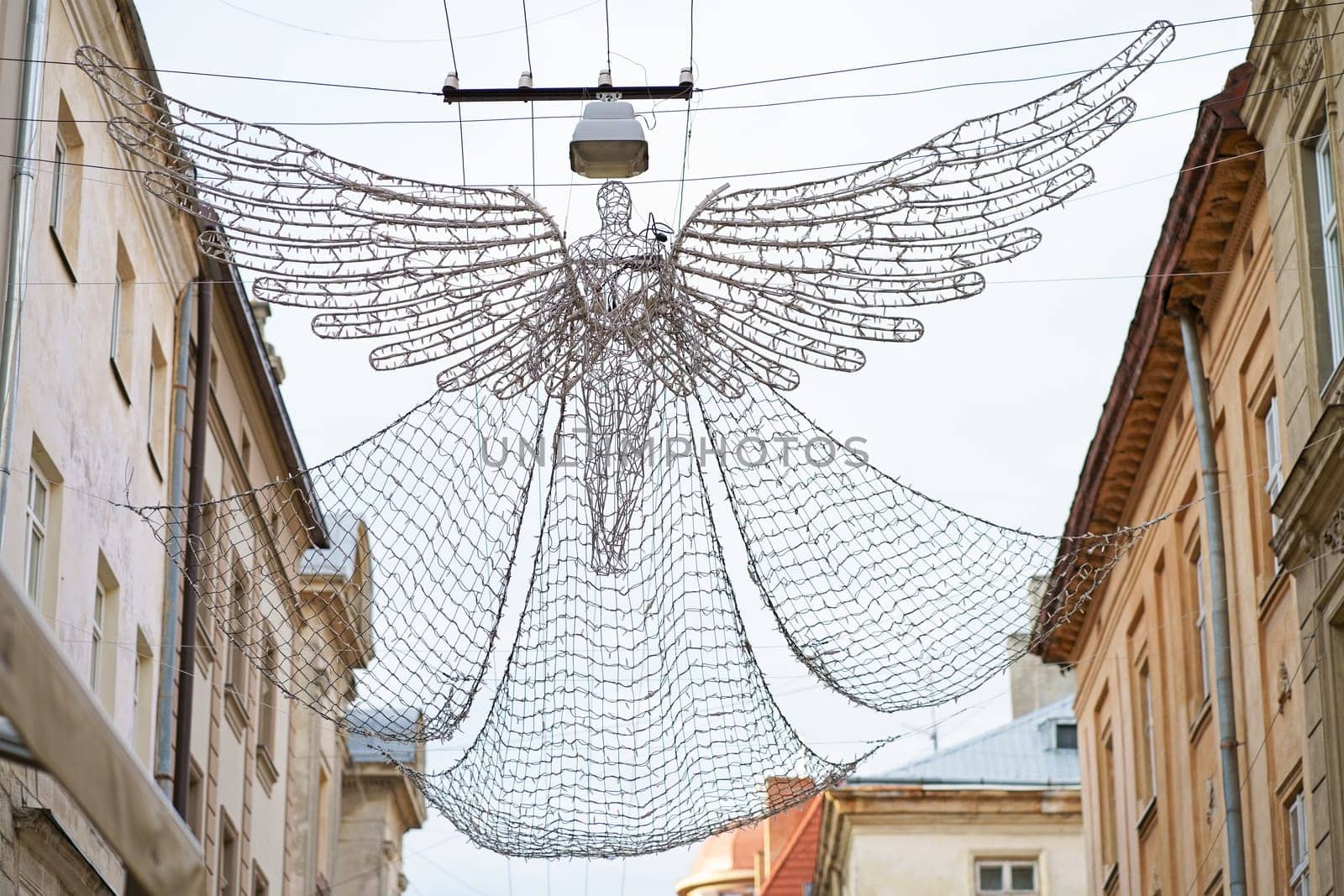 Ukraine. Lviv. Market Square. Street lighting garland in the form of an angel flying over the city by aprilphoto