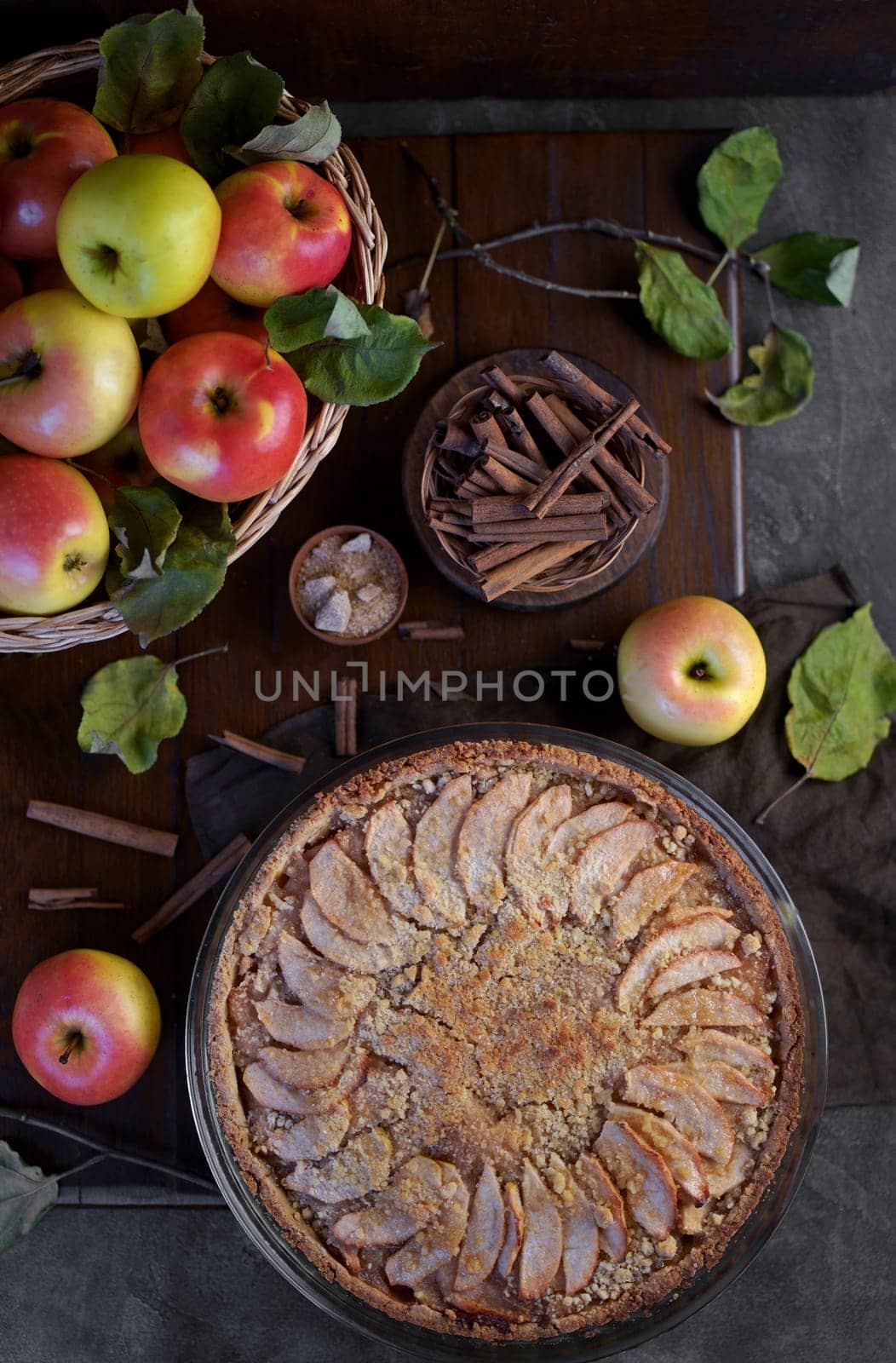 Home made apple pie with fresh fruits on a wooden table