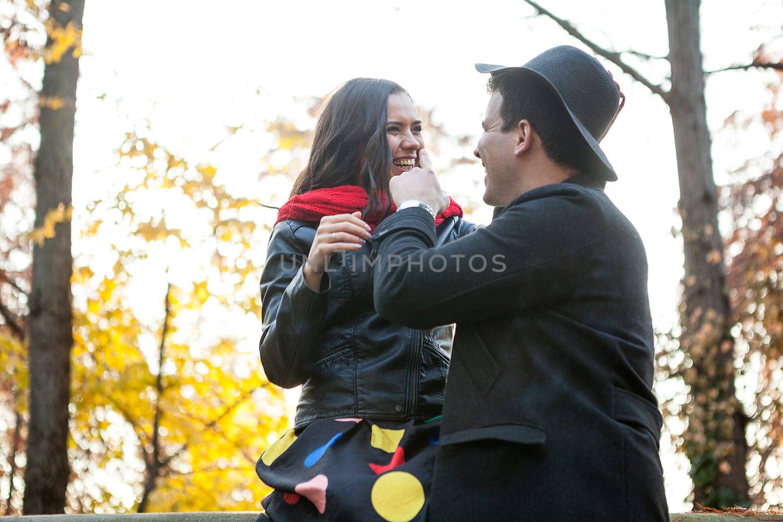 Beautiful in love happy couple in autumn park having fun