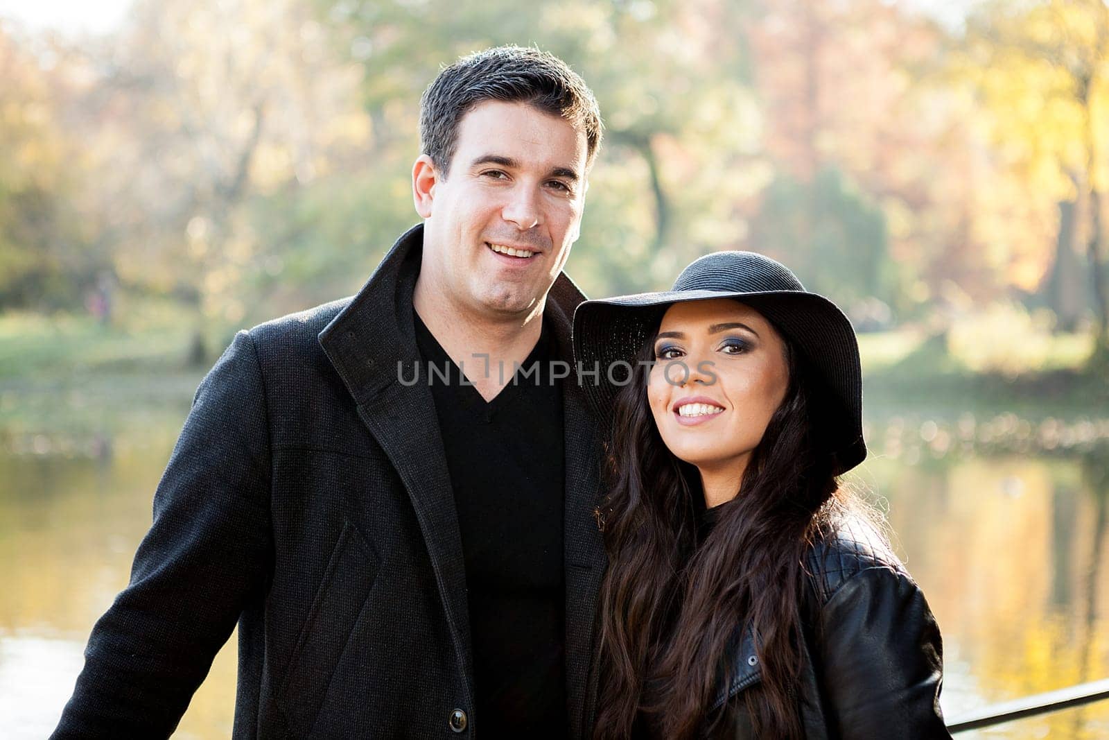 Beautiful gourgeous couple walking in an autumn park