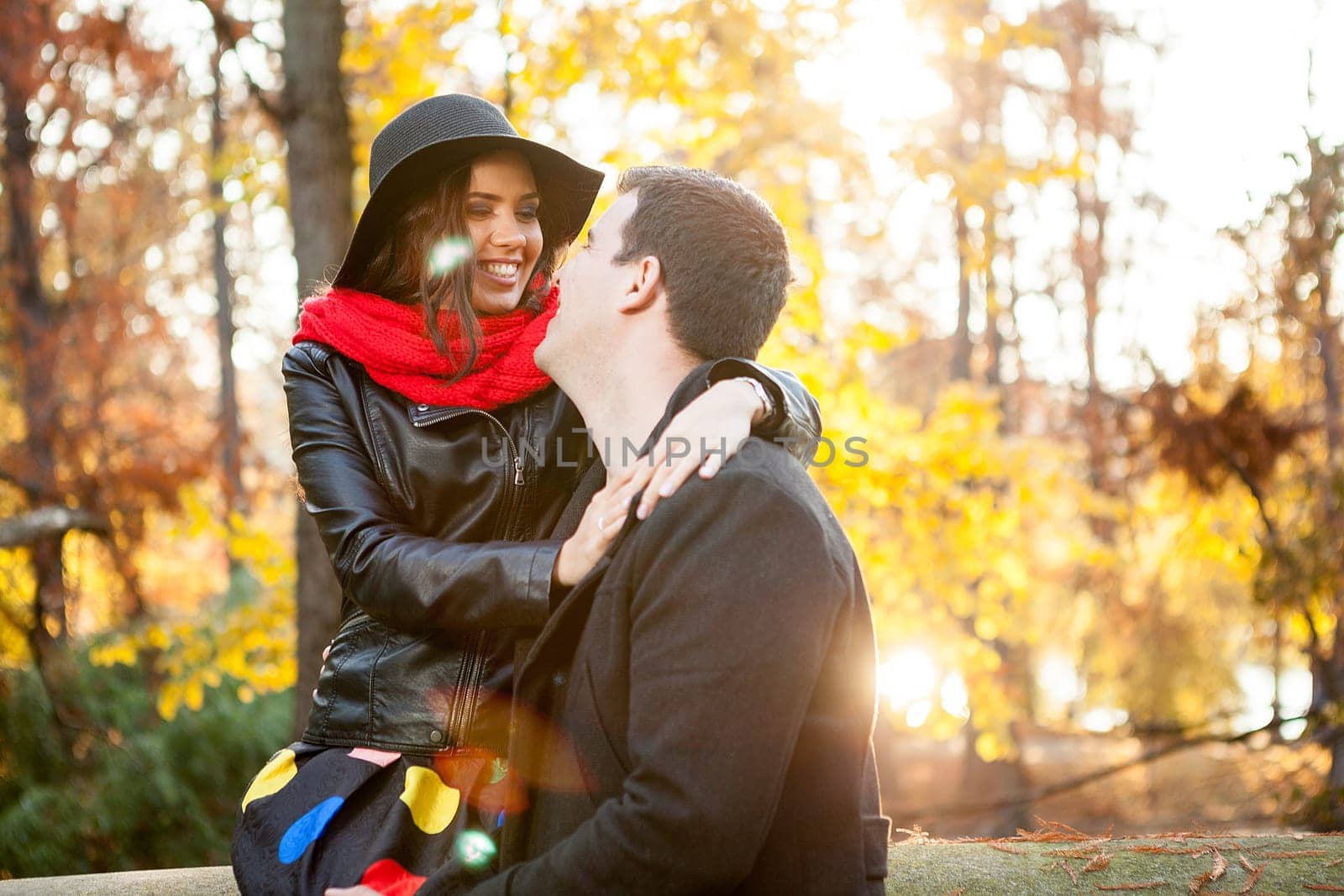 Beautiful happy couple in autumn park relaxing