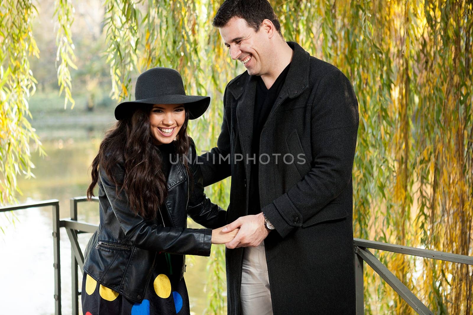 Beautiful smiling couple walking in autumn park