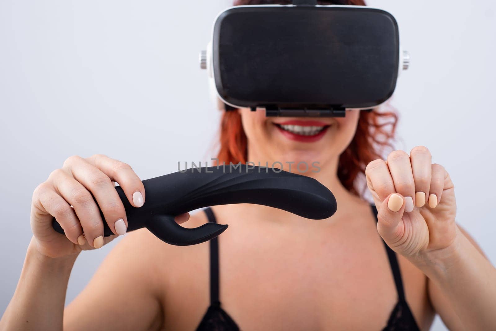 Woman in VR glasses with a black dildo on a white background. The girl masturbates and watches 3d porn by mrwed54