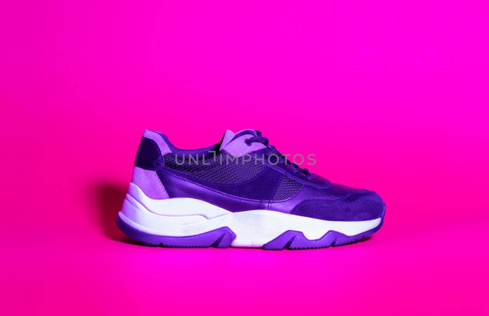 Trendy woman sneakers shoes, trend duotone neon ultraviolet color lightning. Colored light pink, magenta, creative trendy effect. by Ri6ka