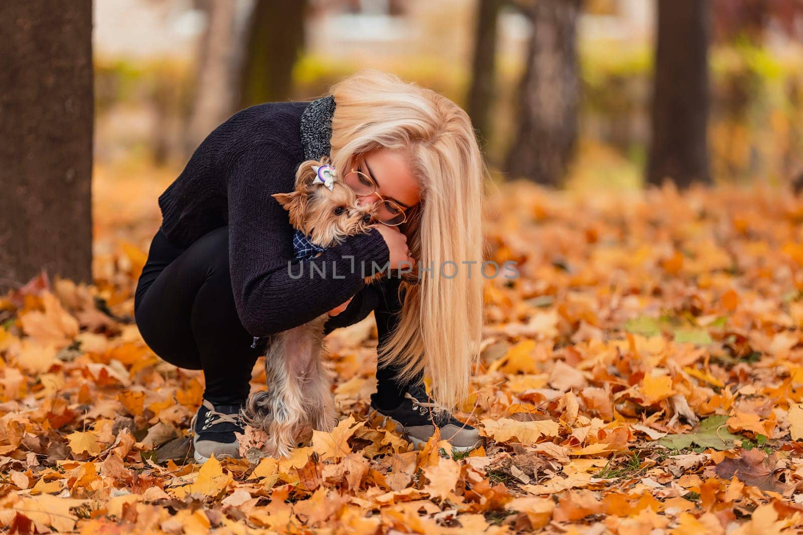 girl with her little dog in autumn park