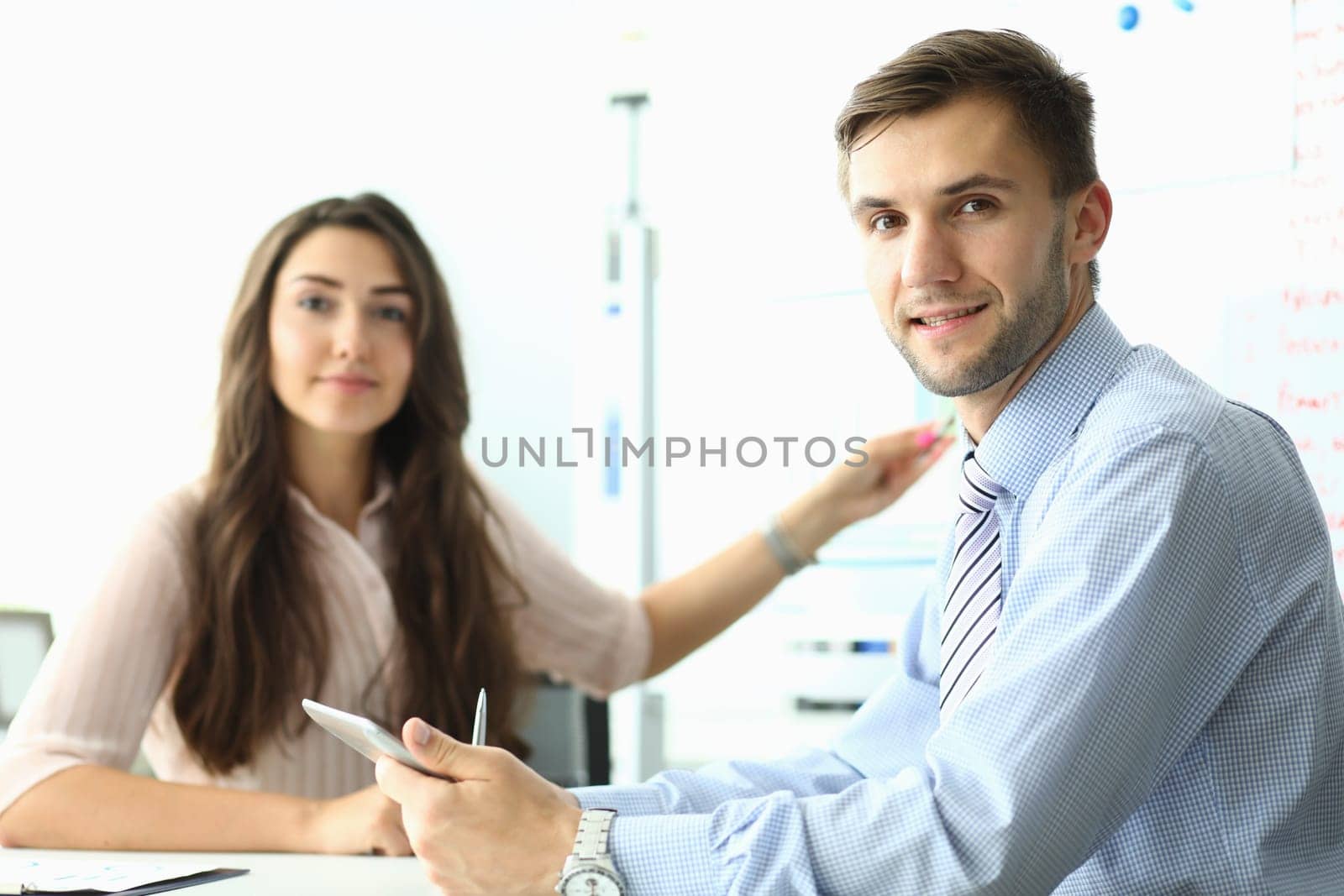 Portrait of business people sitting in office in meeting. Teamwork and business project concept