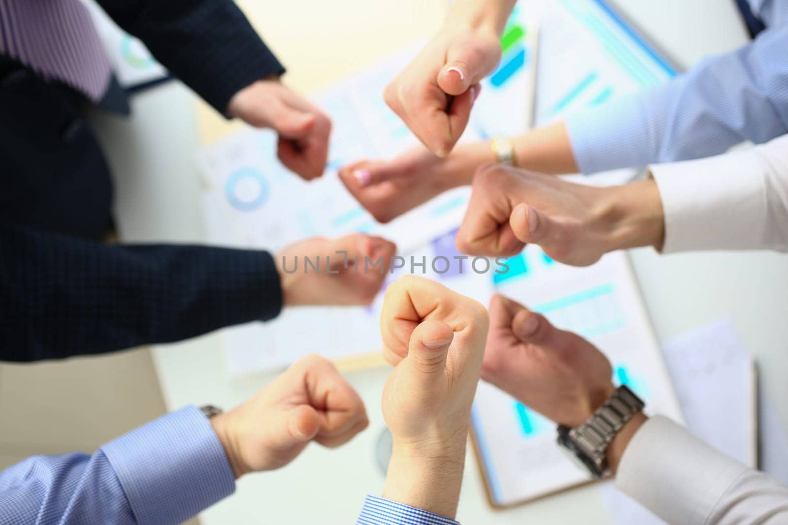 Closeup of business people hands showing thumbs up top view by kuprevich