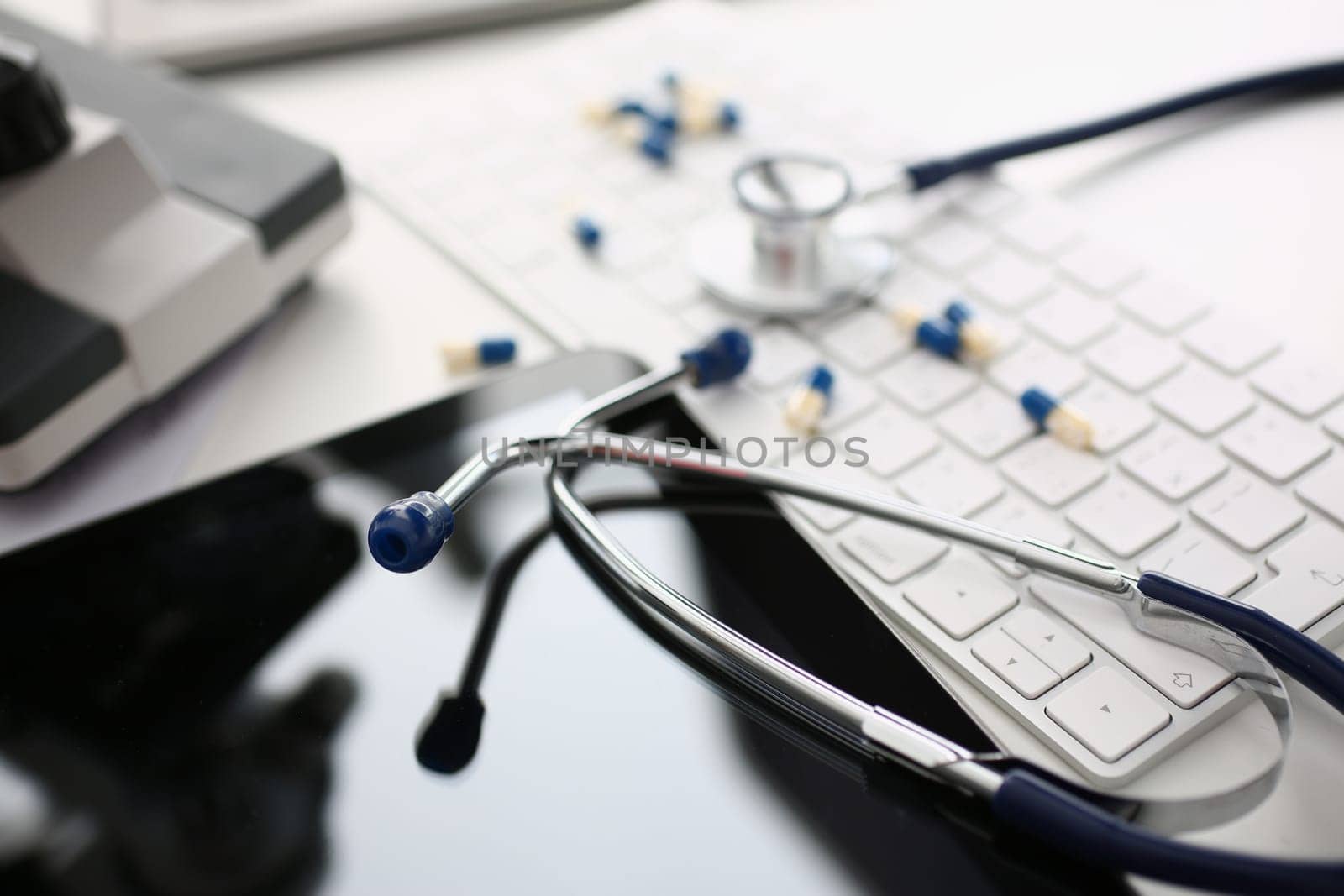 Medical pills or vitamins with keyboard and stethoscope. Medicine or pharmacy concept online order