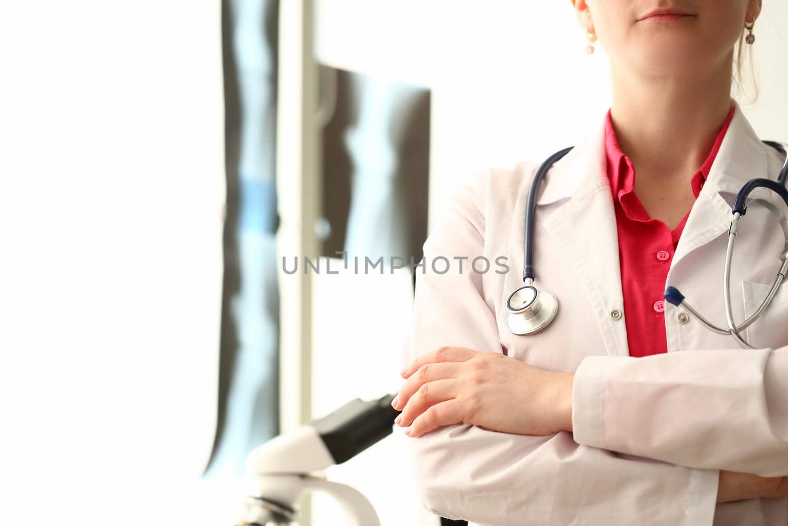 Silhouette of doctor with crossed arms in clinic. Health insurance and services concept