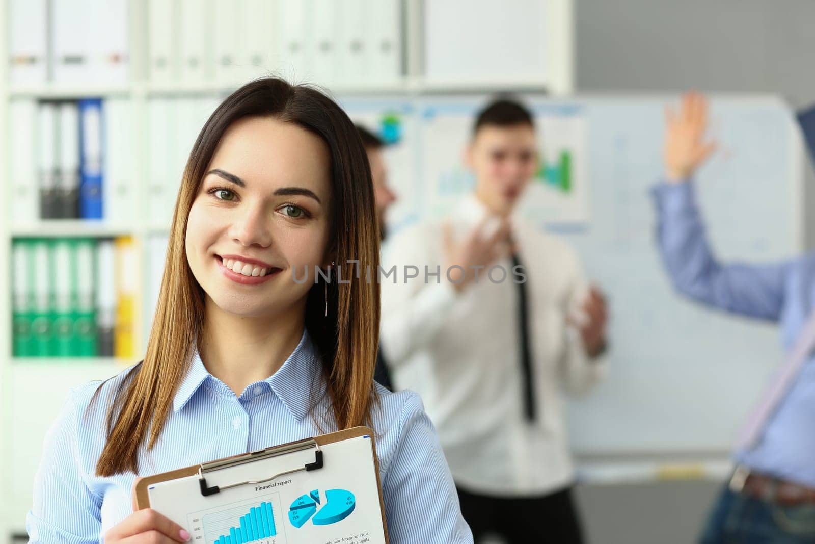 Business woman with staff and group of people in background in office. Educational seminar lecture concept