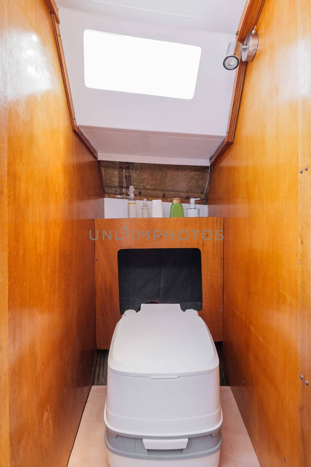 Cozy bathroom in small yacht with wooden walls. Compact stylish modern thoughtful yacht. Concept of comfortable conditions while traveling. by apavlin