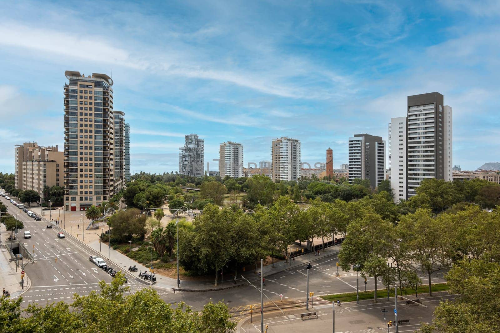 Aerial view of modern high-tech area of Barcelona - Diagonal Mar with high standard of living on the blue sky background. Concept of comfortable life in Spain near the sea.
