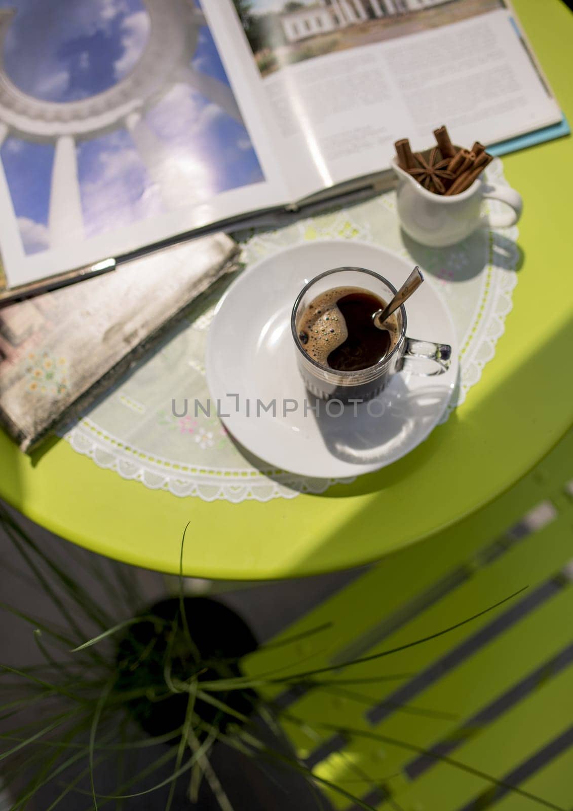 Tourism concept. Cup of coffee and books on a table in a cafe