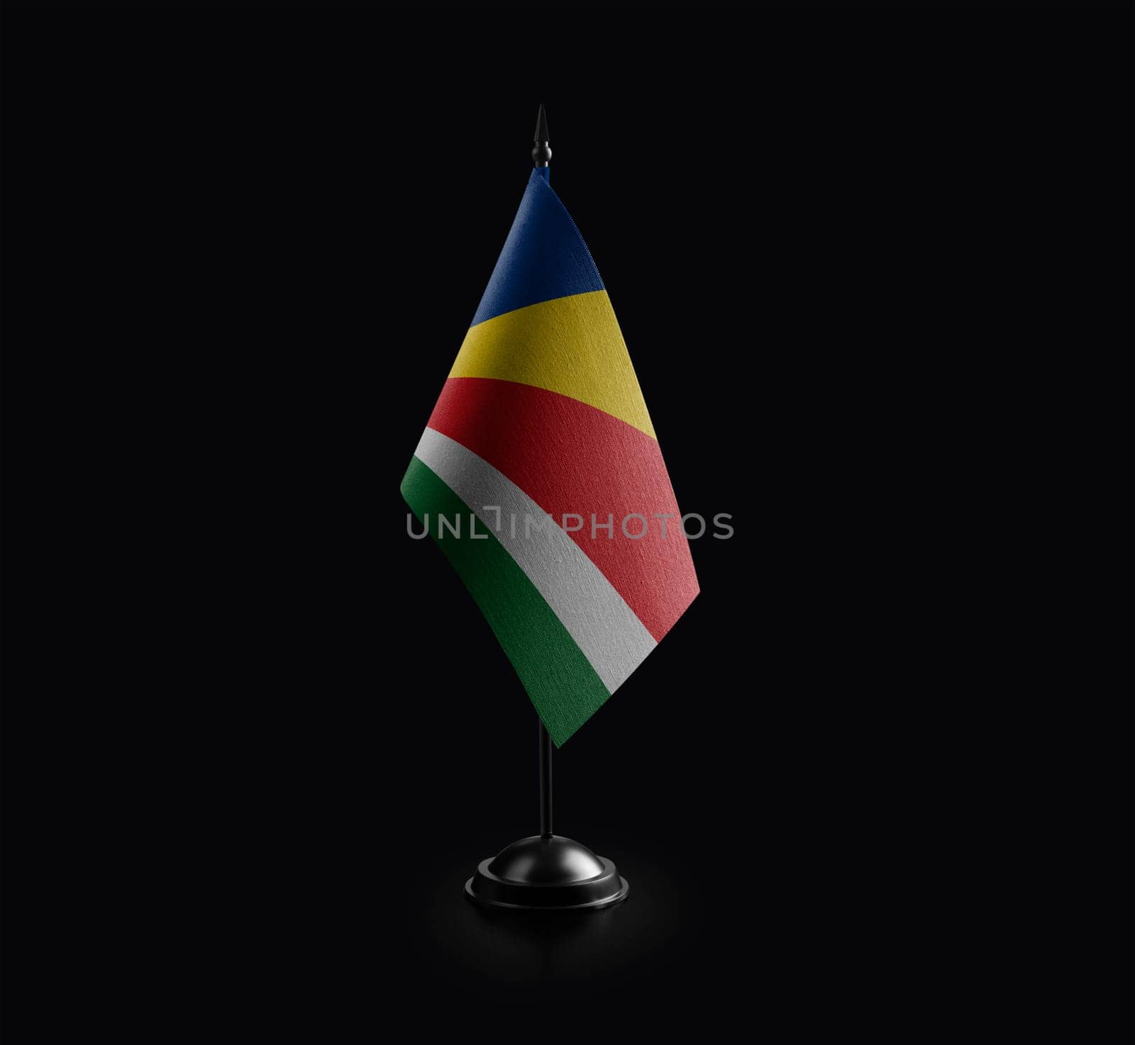 Small national flag of the Seychelles on a black background by butenkow