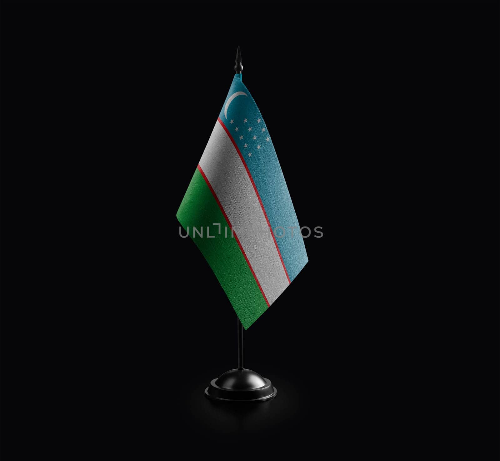 Small national flag of the Uzbekistan on a black background by butenkow