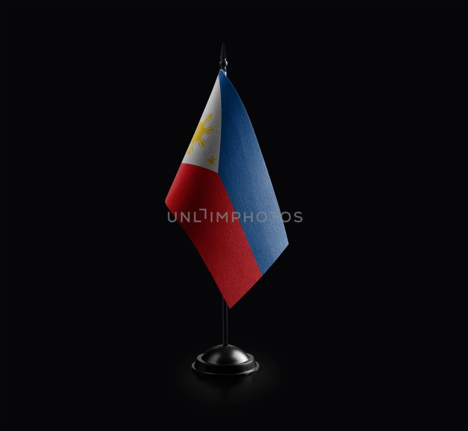 Small national flag of the Philippines on a black background.