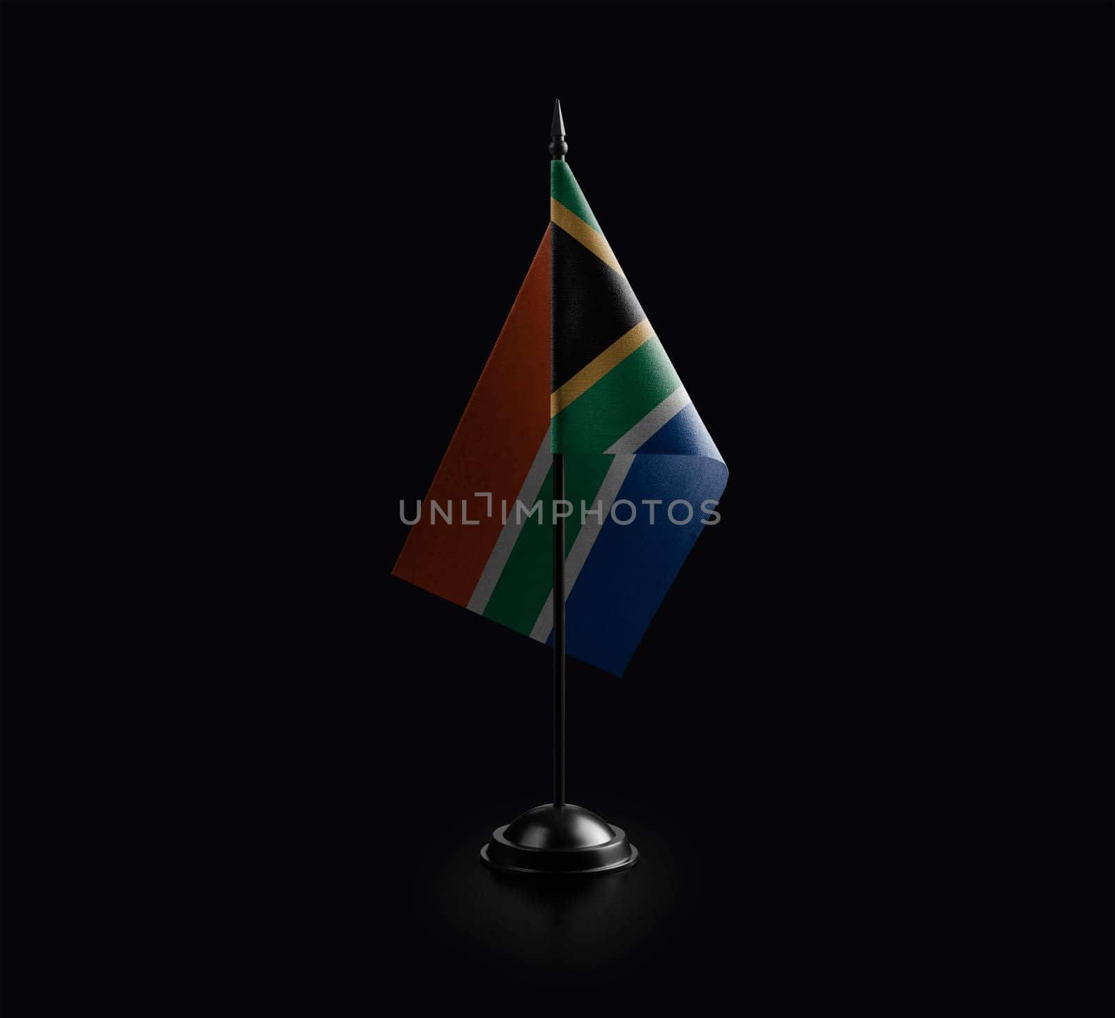 Small national flag of the South Africa on a black background.