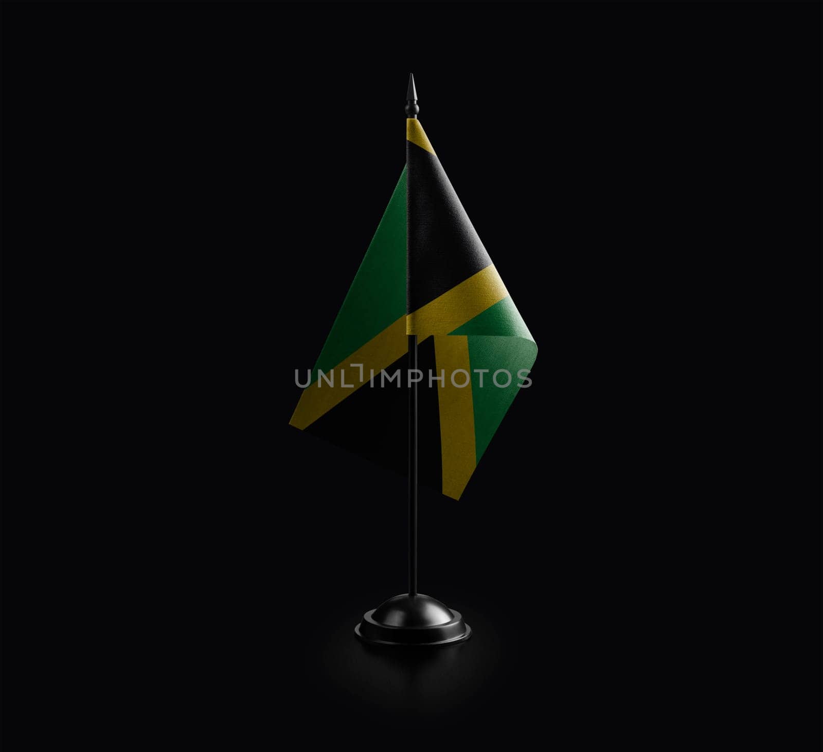 Small national flag of the Jamaica on a black background.