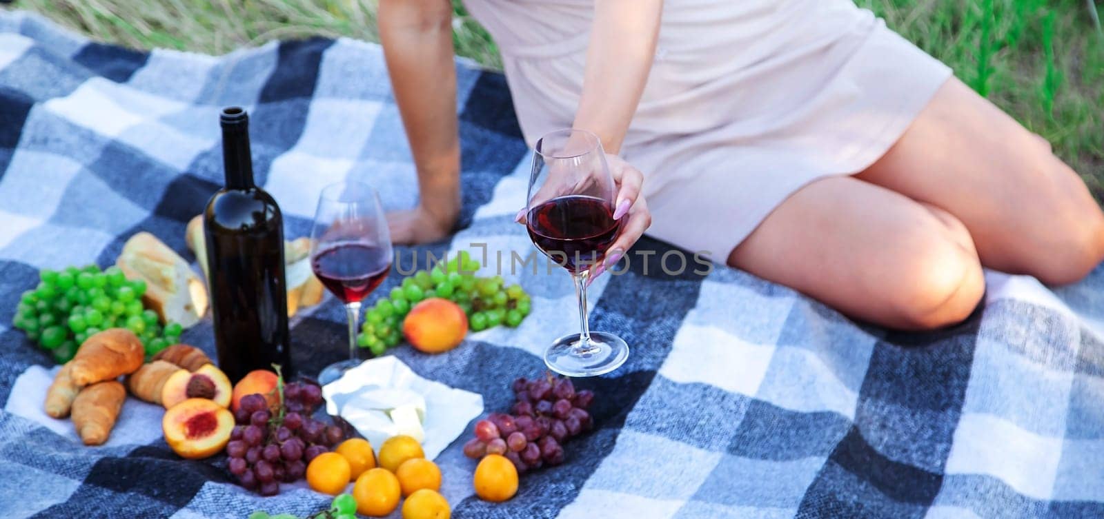 picnic in nature, girl pouring wine, couple in love. nature. selective focus