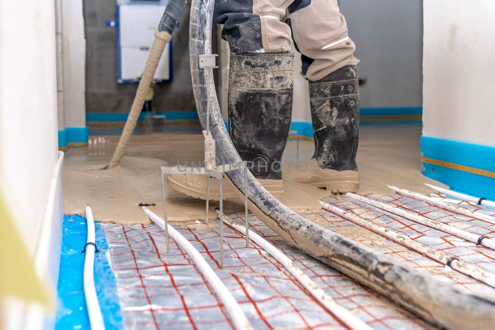 covering the floor heating with anhydride and concrete. High quality photo