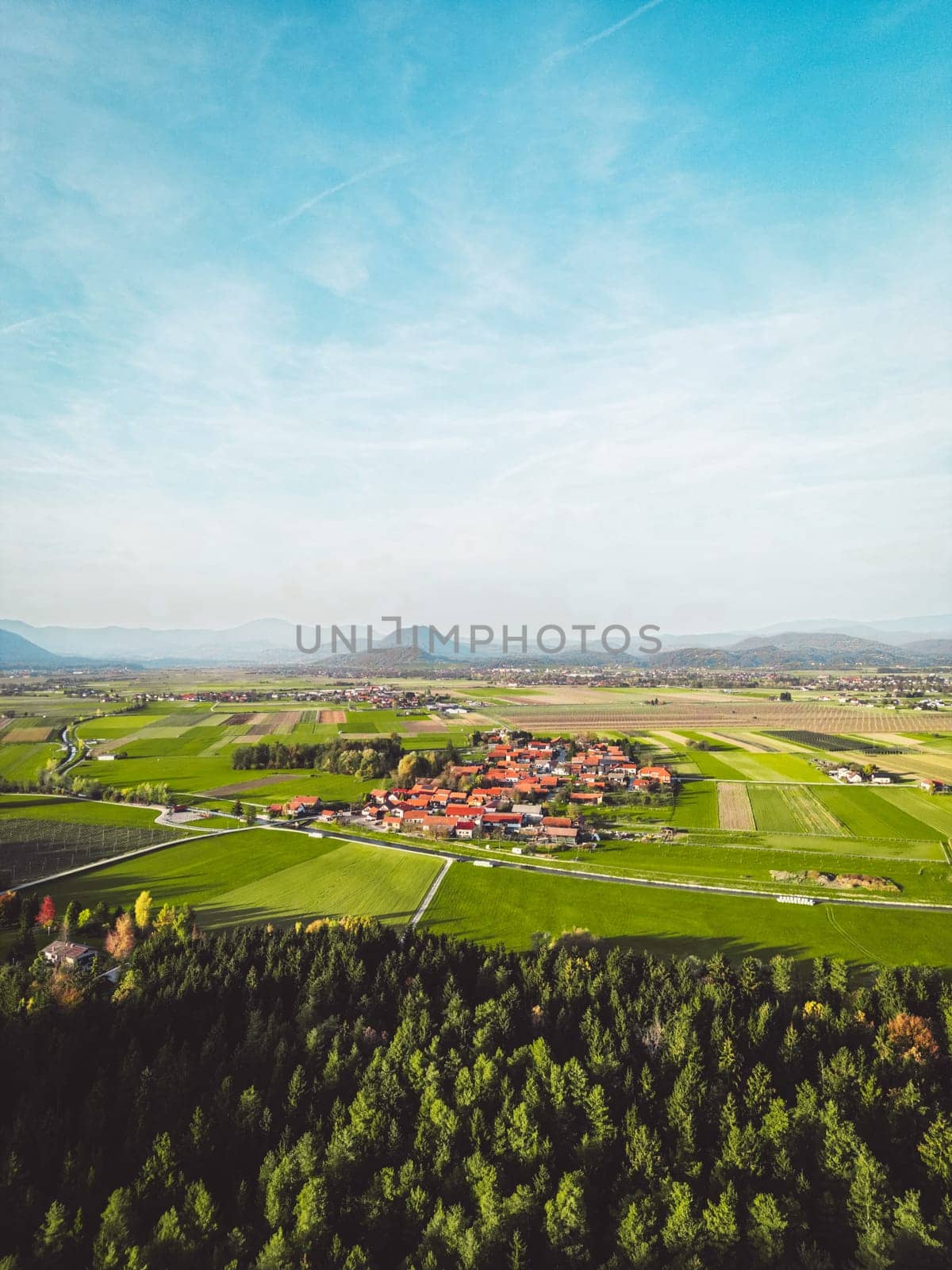 Vertical photo view of the country with some densely populated areas and a lot of green agricultural fields by VisualProductions