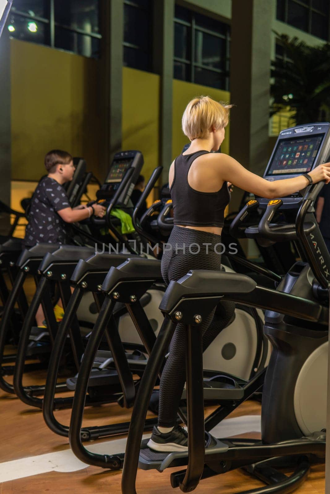 Elliptical trainer young training health, In the afternoon fitness gym for cross healthy coach, class elliptical. Cardio lifestyle background, trainer