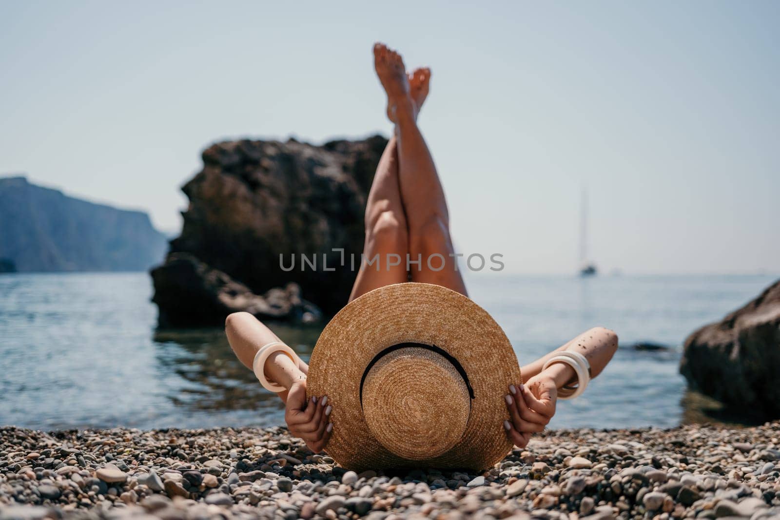 Woman travel sea. Happy tourist taking picture outdoors for memories. Woman traveler looks at the edge of the cliff on the sea bay of mountains, sharing travel adventure journey.