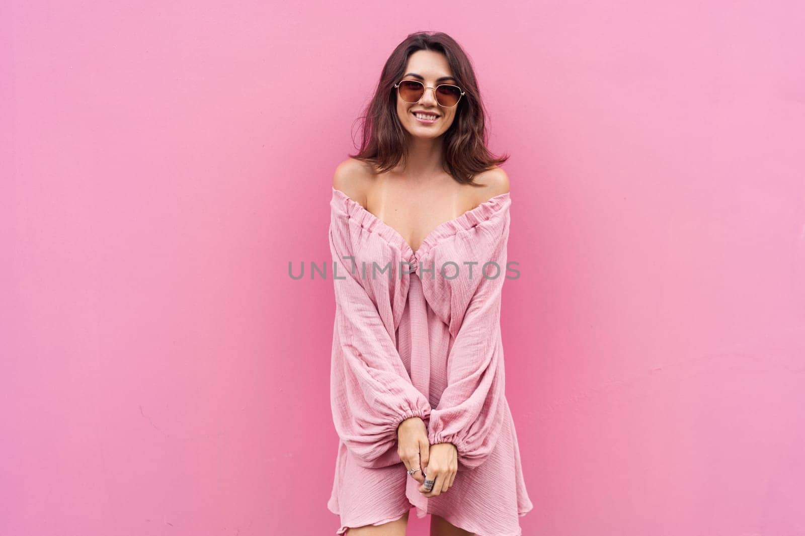 Young beautiful smiling cute romantic woman in trendy summer dress. Carefree woman posing in the street near pink wall. Positive model outdoors in sunglasses. Cheerful and happy. by kroshka_nastya