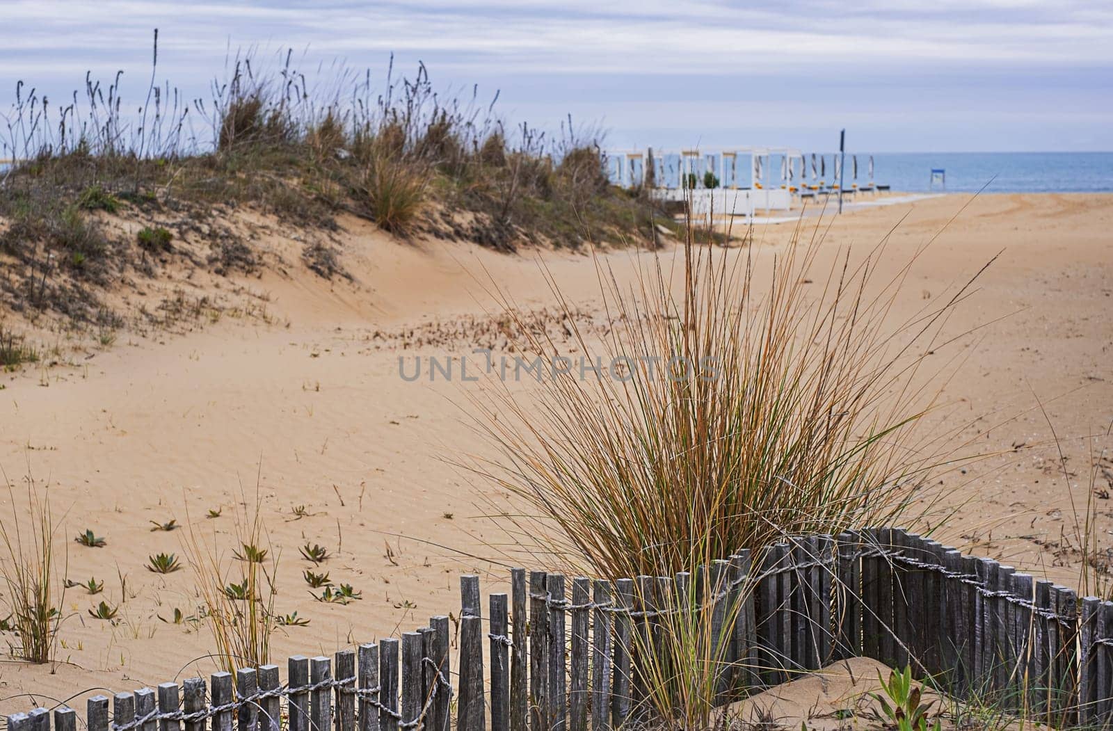 View of the deserted beach and the endless sea on a cloudy day.