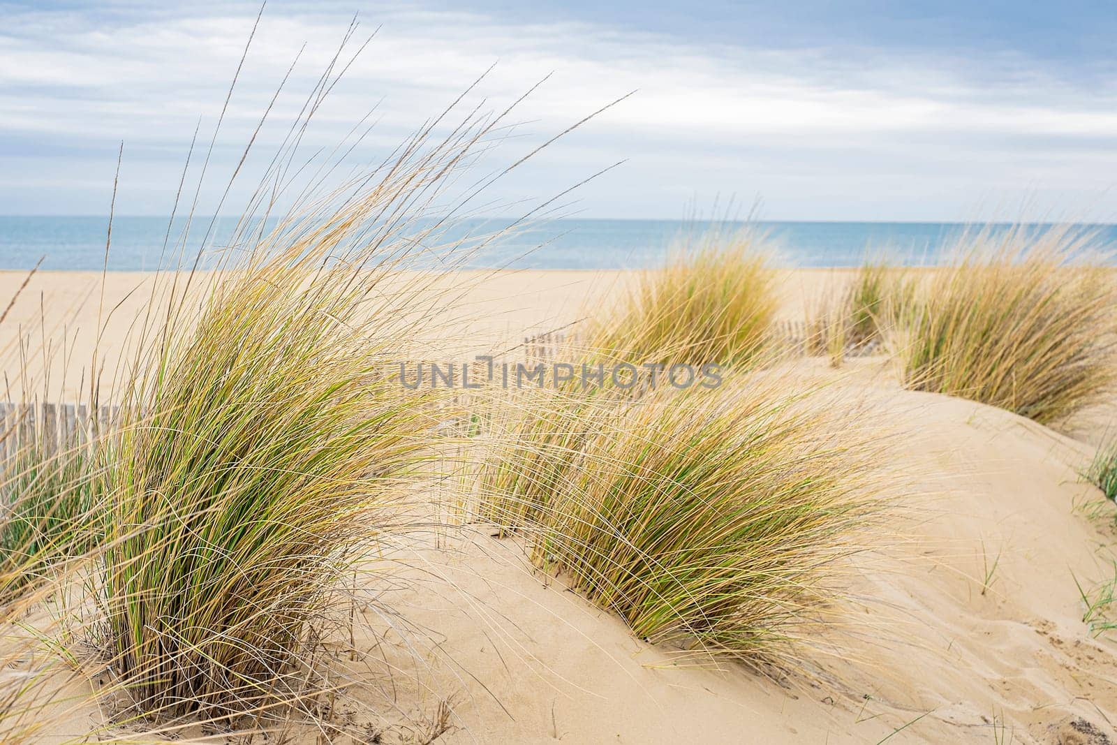 View of the deserted beach and the endless sea on a cloudy day.