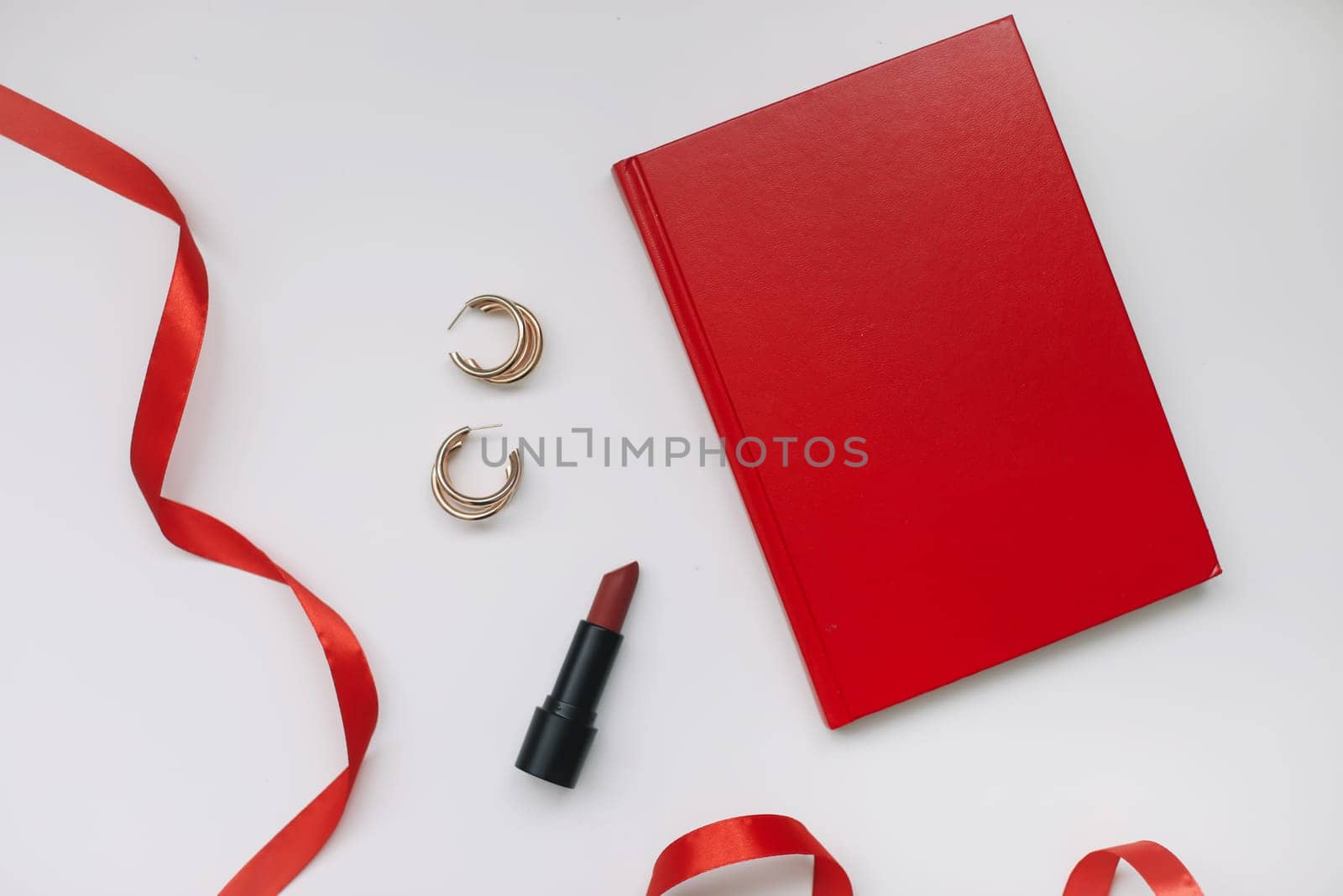 Concept Women's Day, Valentines Day, March 8. Book, lipstick, cosmetic makeup products and accessories flatlay top view. by paralisart