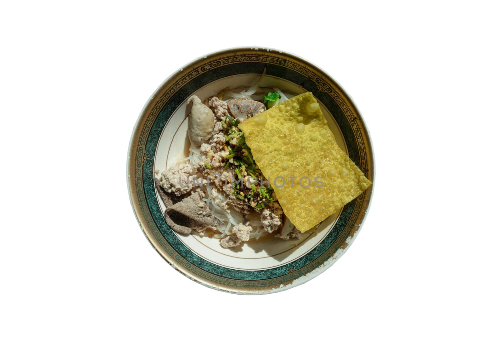 Steamed Thin rice noodles without soup with Meatball, Fish sticks, Minced pork, Boiled pork liver and Fried wonton topped with crackling and chopped dried chili in Bowl isolated on white background with clipping path. Traditional asian food style, Top view, Selective Focus.