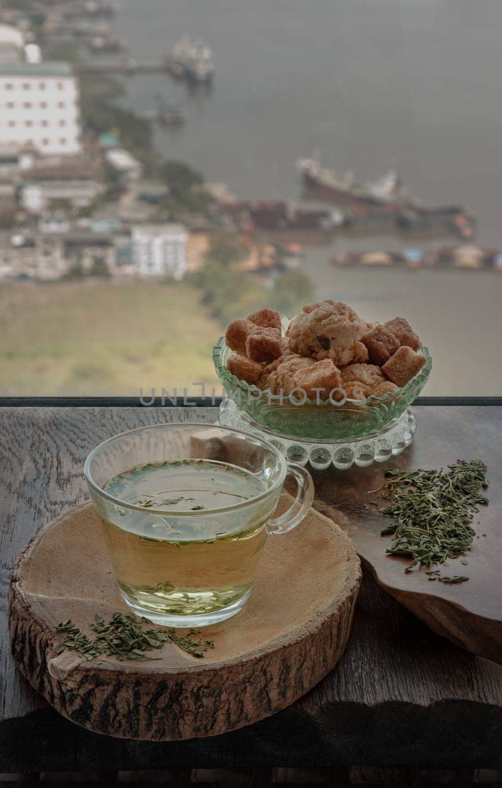 Refreshing and Enjoy with A cup of Hot Hemp Tea (CBD herbal tea) served with Scones and Croutons on old rustic wooden table by the window view with sunlight. Healthy drink concept. Space for text.