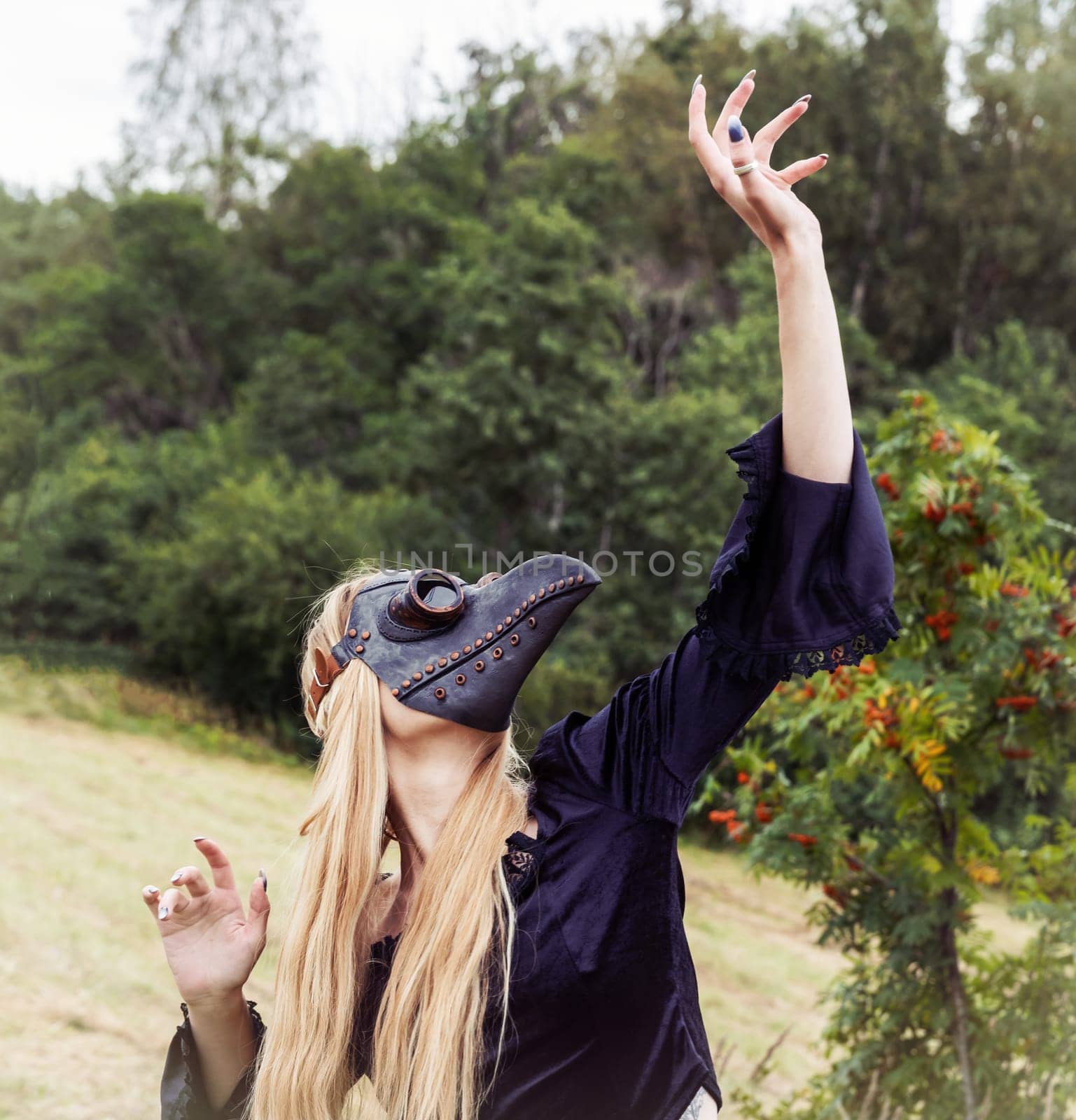 A mysterious and surreal portrait of a young woman in a plague mask.