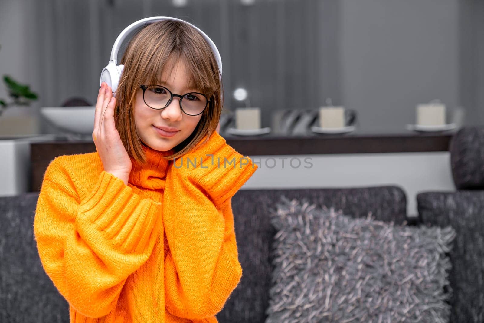 child listens to music in wireless headphones.
