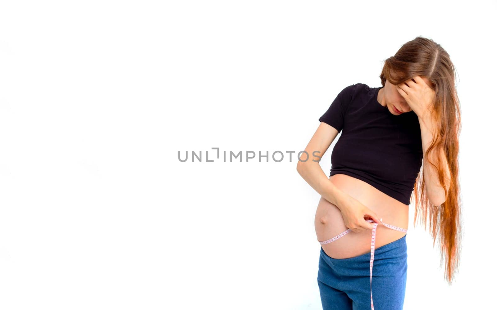 Pregnant woman measuring stomach with measuring tape. Banner with copy space