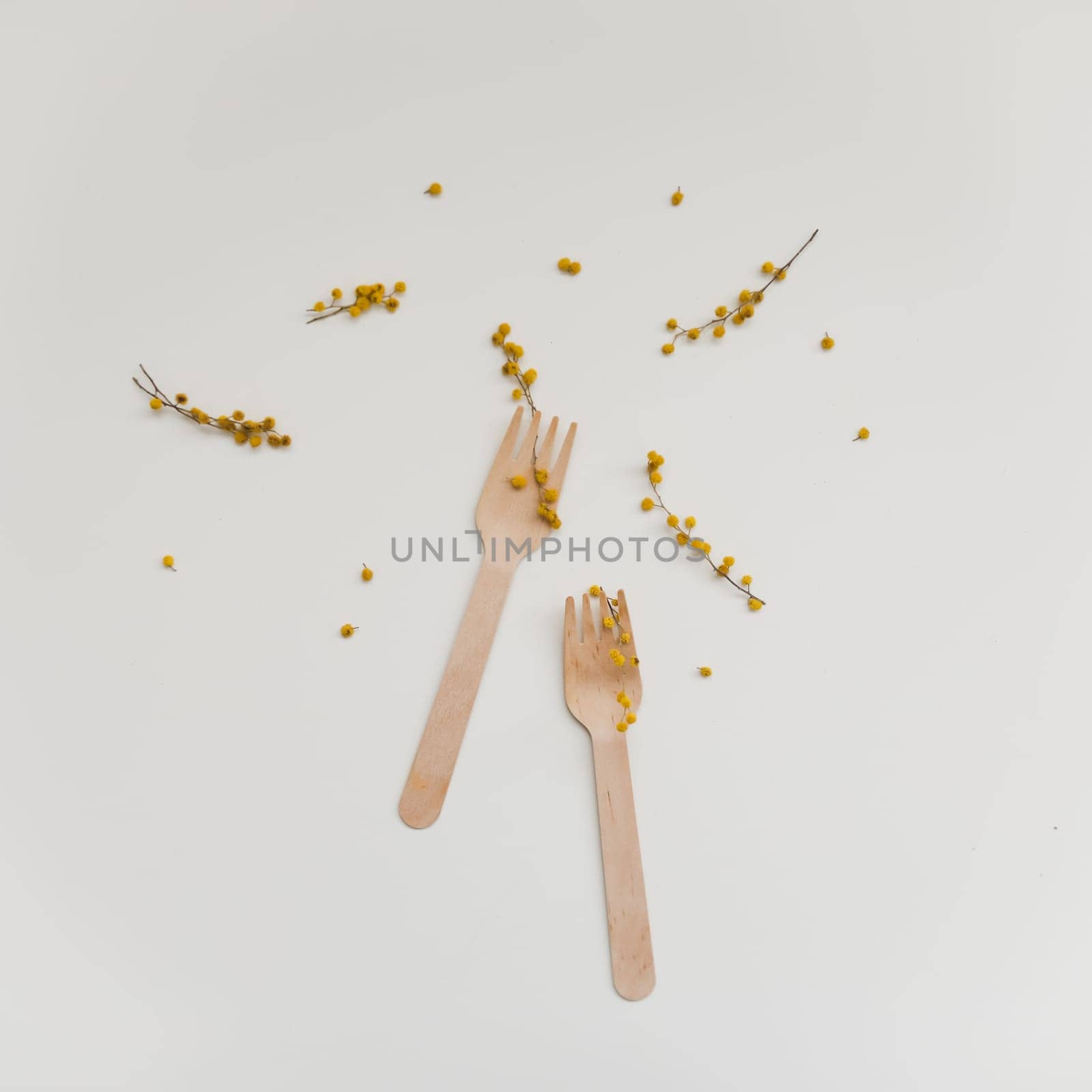 Cutlery with flowers on white textured background. Sustainable lifestyle, no plastic concept, zero waste